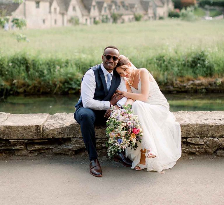 Bride & groom kiss outdoors 