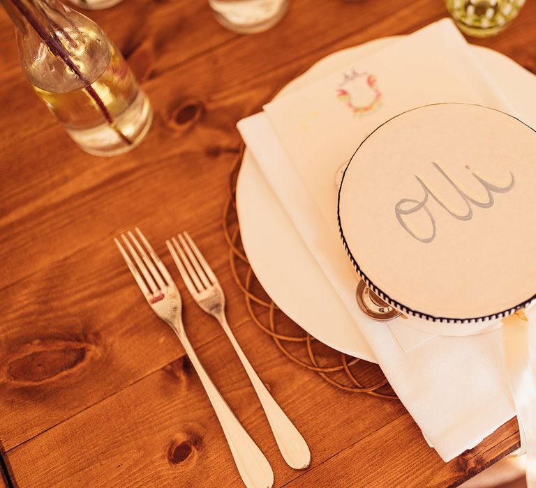 Tambourine wedding table place name on wooden table for marquee wedding reception