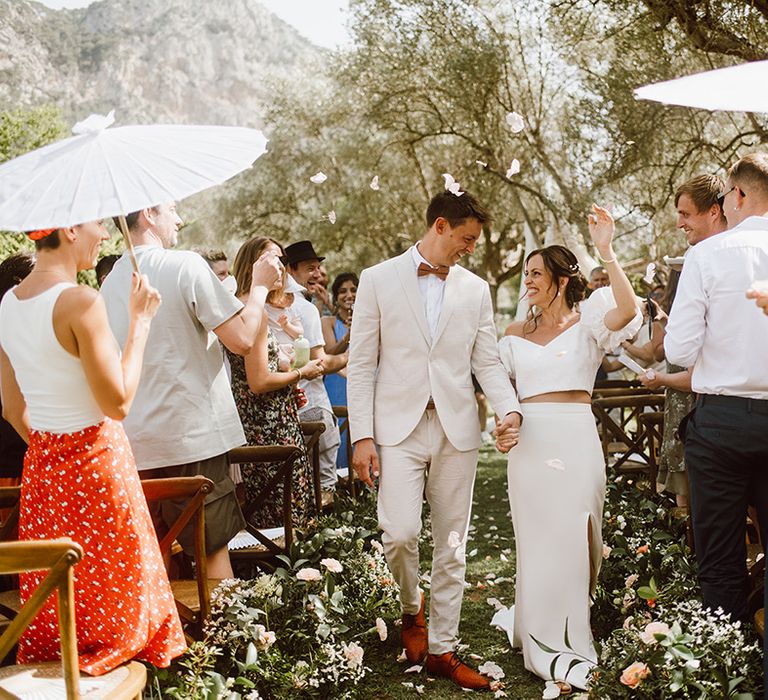 Bride and groom walk down the aisle as a married couple