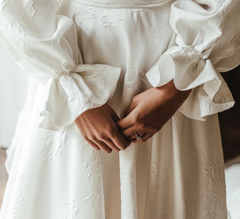 Textured Emma Beaumont wedding dress with puff sleeves and off the shoulder detail