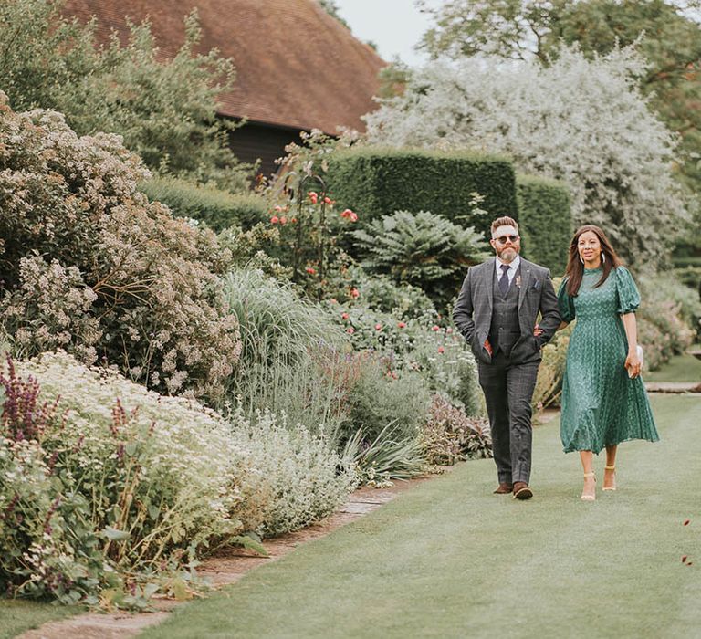 Wedding guests walk around the grounds of the wedding venue