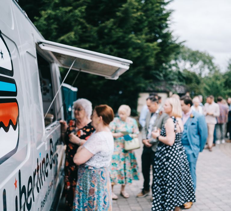 Wedding guests queue at burger van