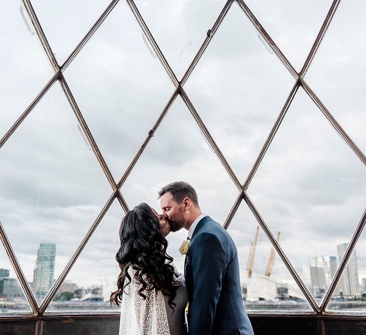 Bride & groom kiss at the top of lighthouse in London after wedding ceremony 