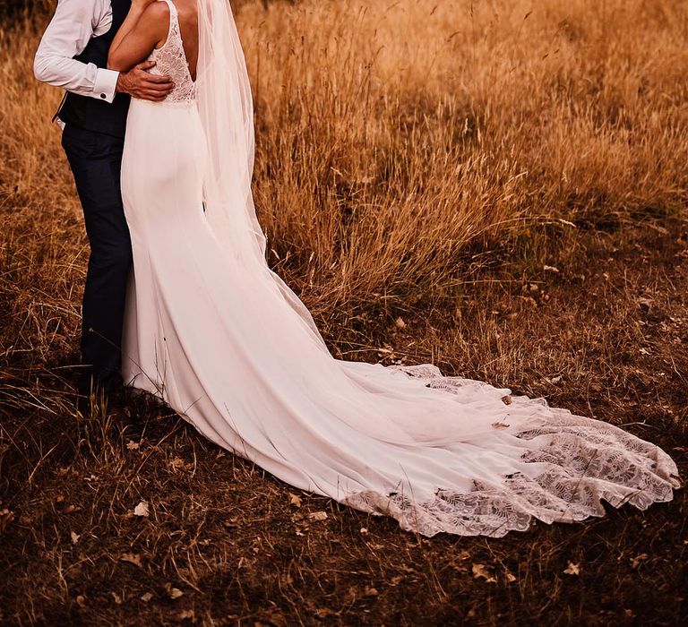 The bride and groom share a kiss as they pose for their couple portraits