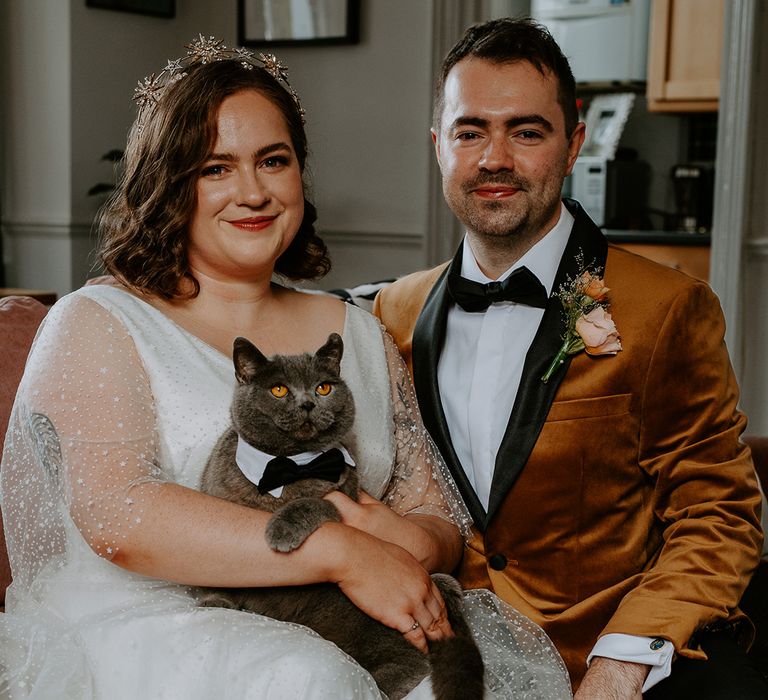 The couple take part in a family portrait with beloved pet cat Bowie. Bowie wears a collar and bow tie