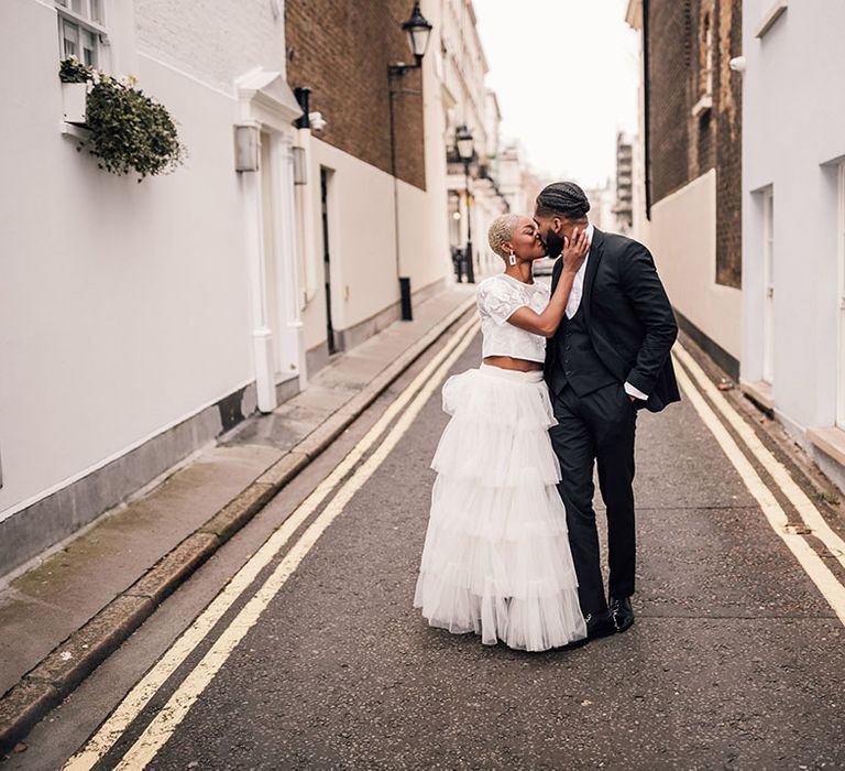 Bride and Groom kiss in the street at London Wedding