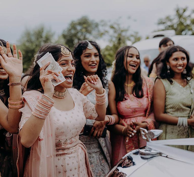 Wedding guests in colourful outfits celebrate marriage at Braxted Park Estate 