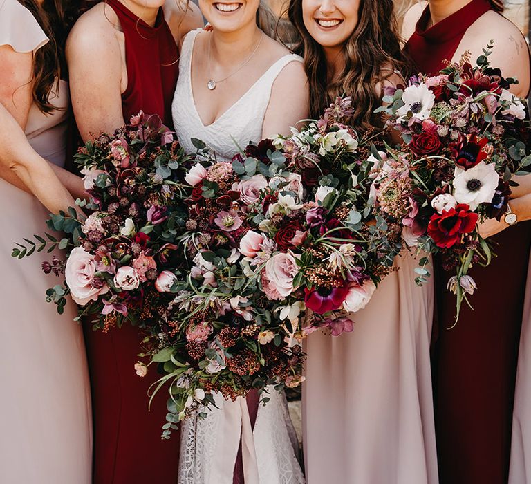 Bridesmaid's bouquets with the brides made up of red and pink flowers to match their red and pink bridesmaid dresses 