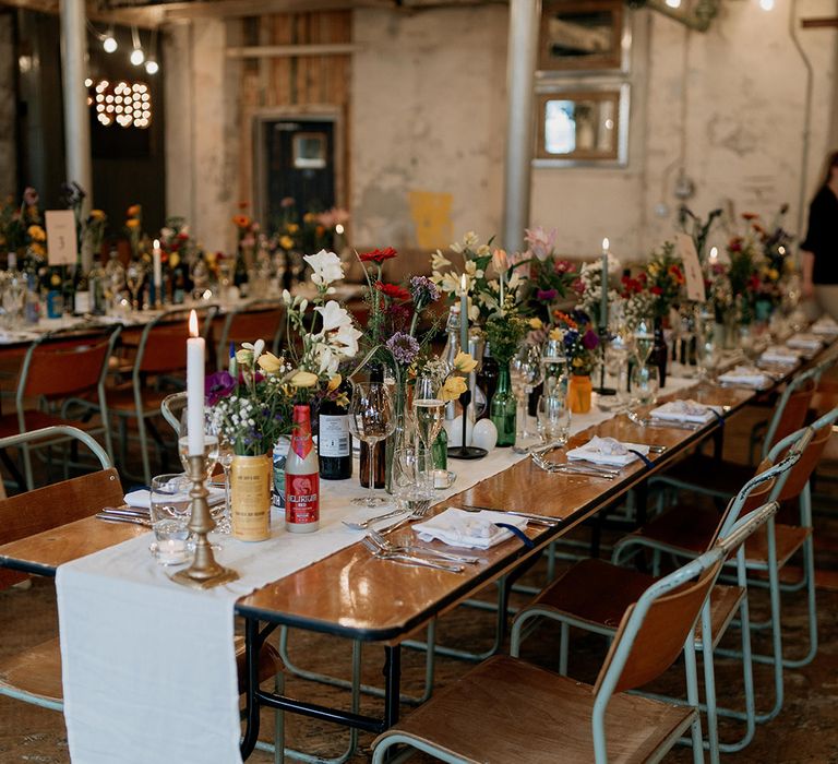 Wildflower wedding theme with a botanical wedding tablescape decorated in colourful wildflower arrangements 