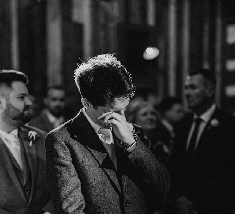 Groom starts to cry as he sees the bride walking down the aisle 