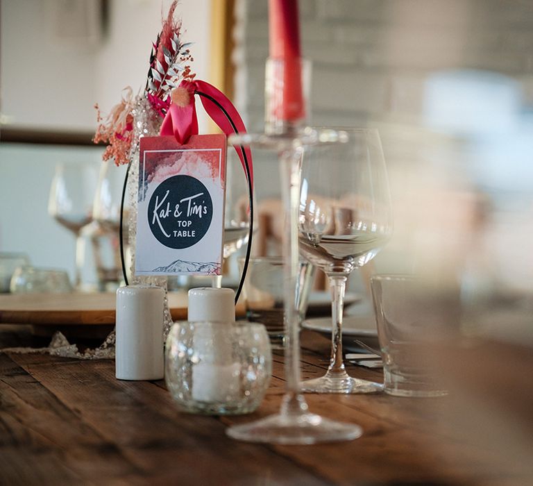 DIY wedding table name sign with handmade hot pink dyed dried wedding flowers 