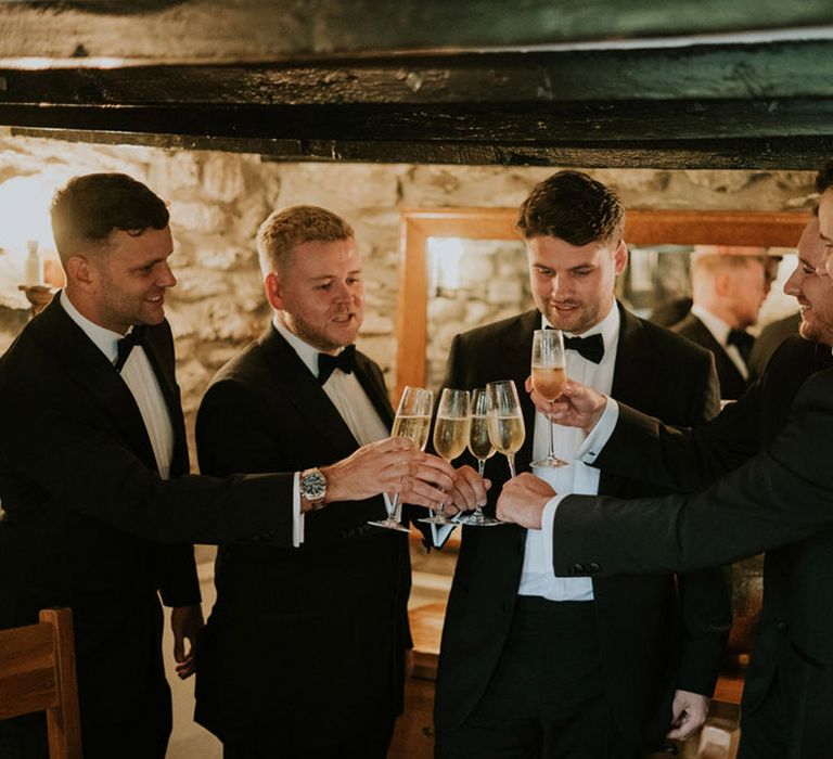 Classic and traditional wedding with the groom and groomsmen in black tuxedos 