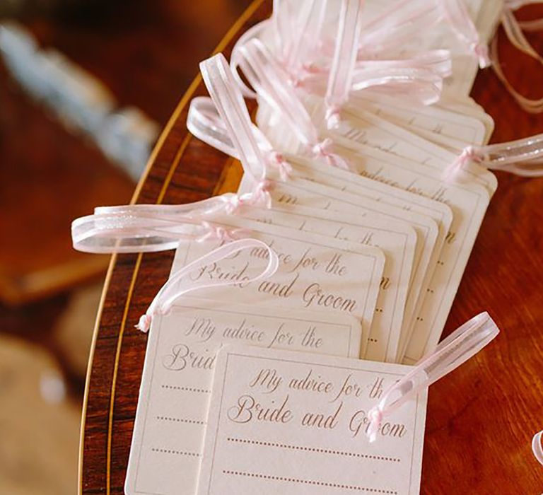 Pink advice cards for guests to write to couple 