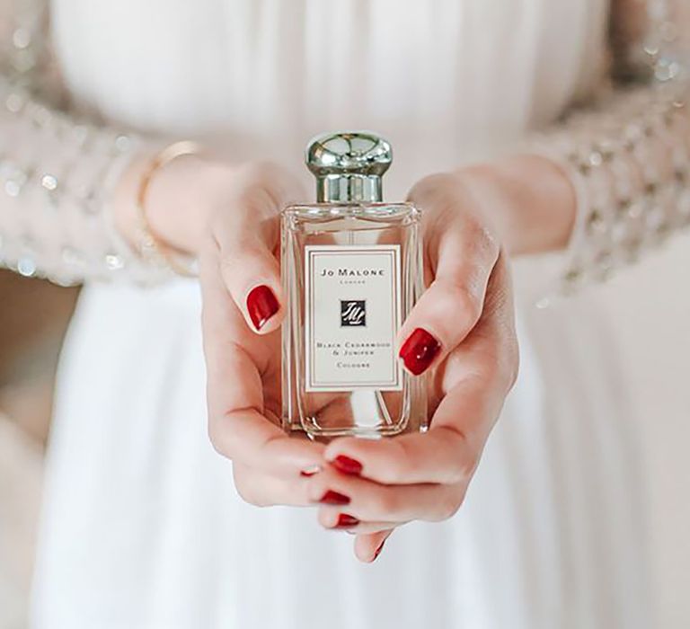 Bride holding Jo Malone wedding scent 