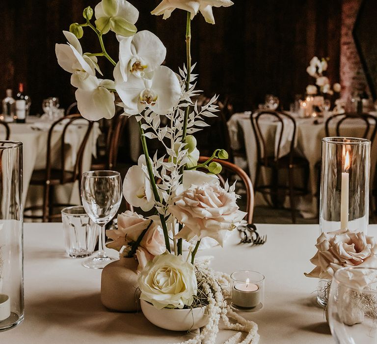 White rose and orchid wedding flower table decorations 