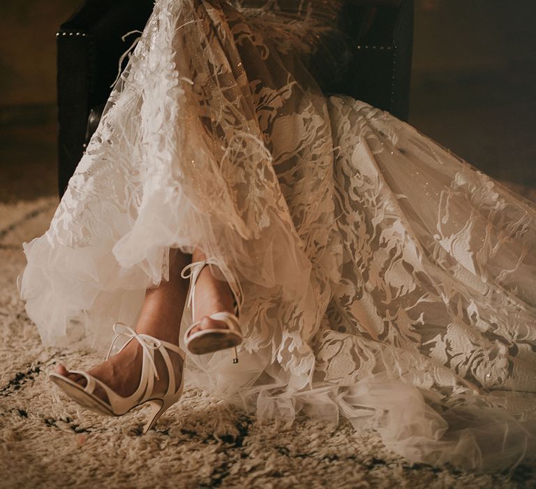 Bride in ankle strap shoes and Berta Bridal wedding dress