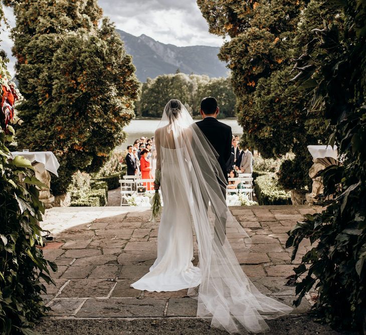 Bride about to walk down the aisle in cathedral length veil 