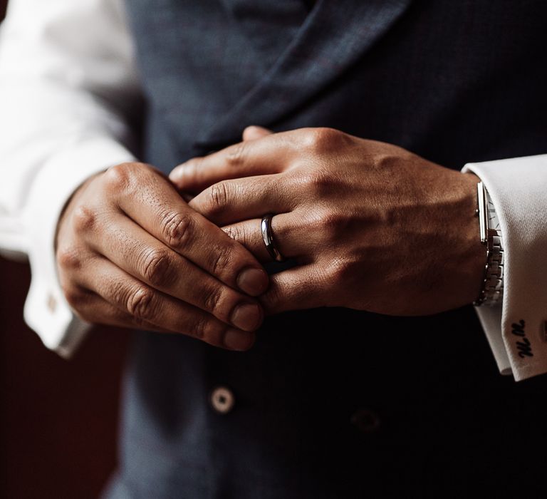 Groom wearing his wedding ring 