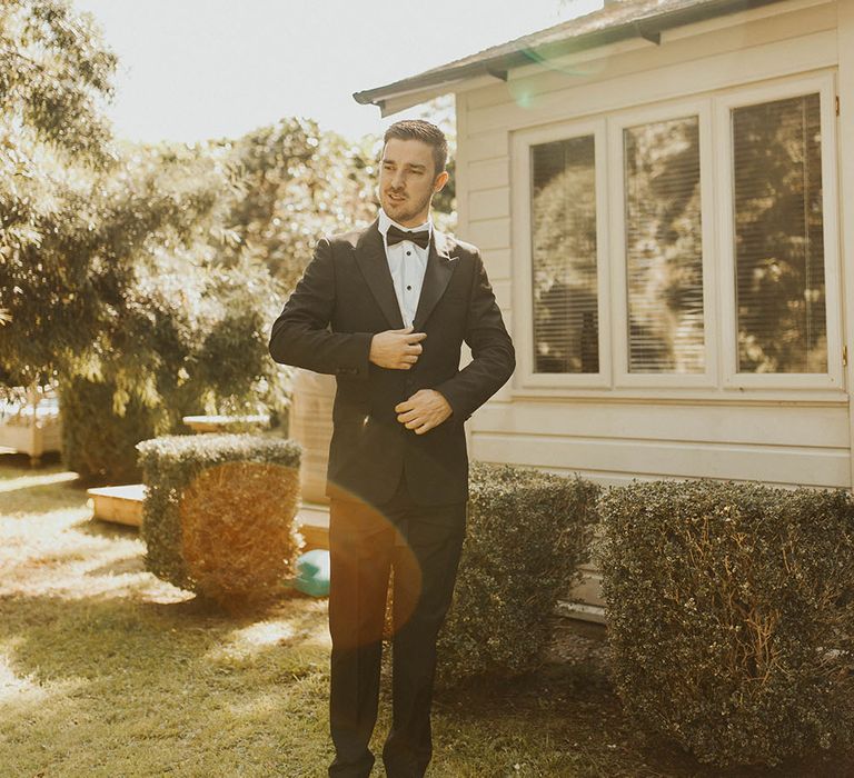 Portrait of a groom in black tuxedo