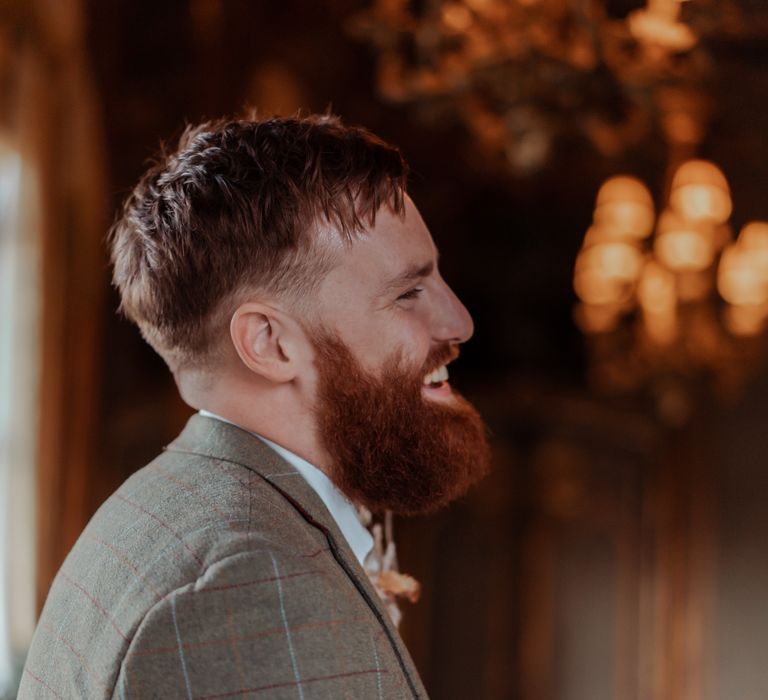 Groom waits for bride in Tweed suit 