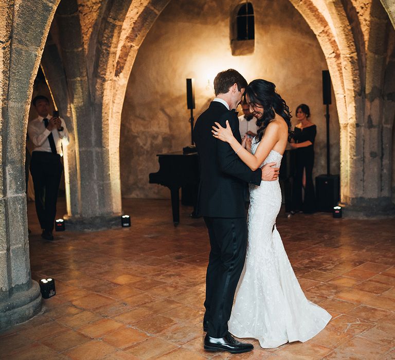 Bride and groom first dance with bride in mermaid wedding dress