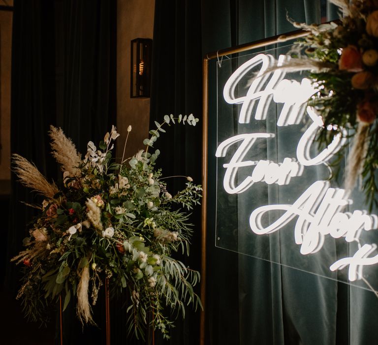 Happily ever after wedding sign with eucalyptus and pampas grass decoration 