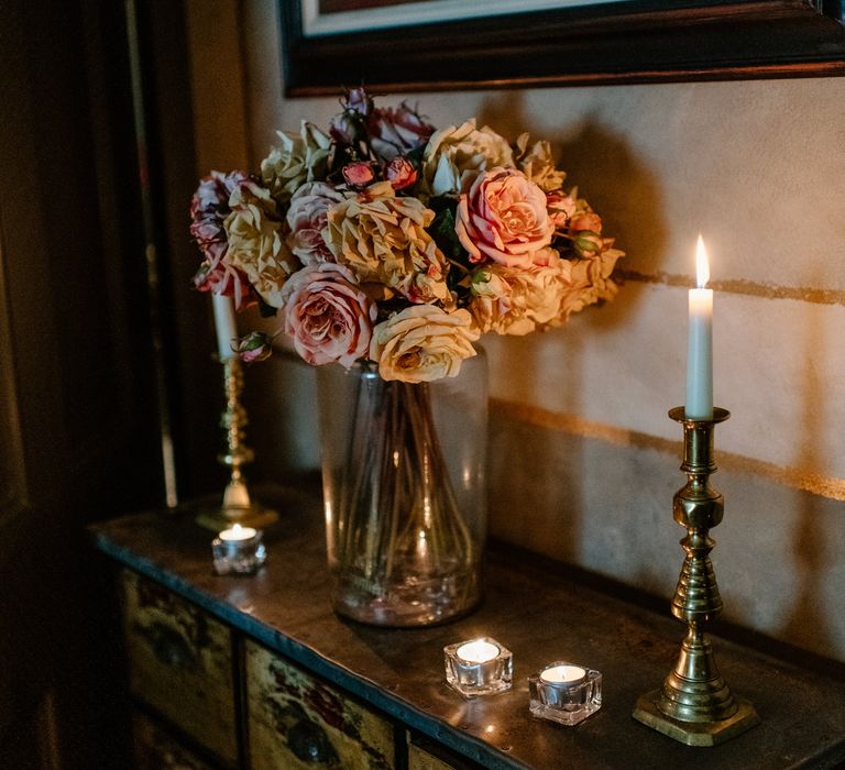 Pink and white rose wedding bouquet with gold candle holders 