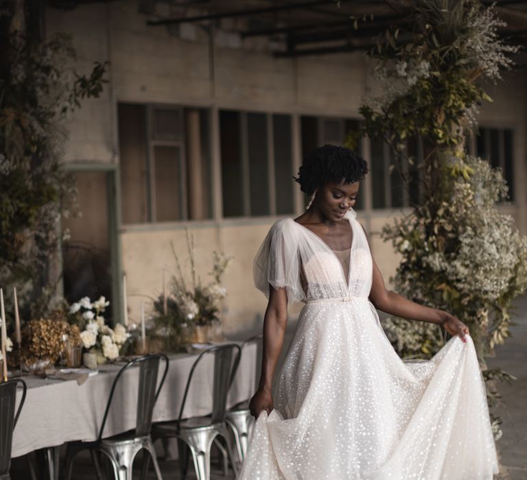 Black bride with short curly hair in Berta bridal gown with v front and bow strap detail 