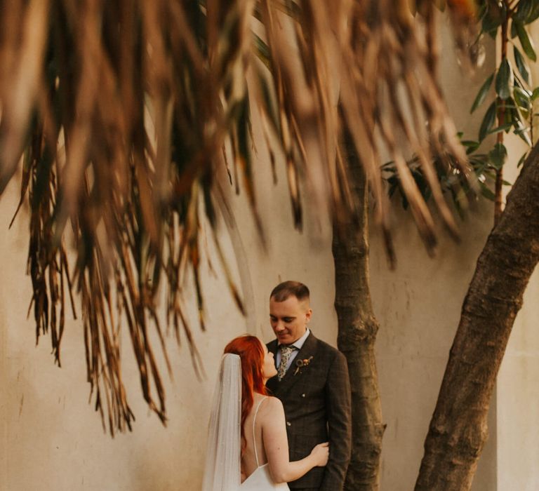 Outdoor autumnal wedding day photograph of bride and groom 