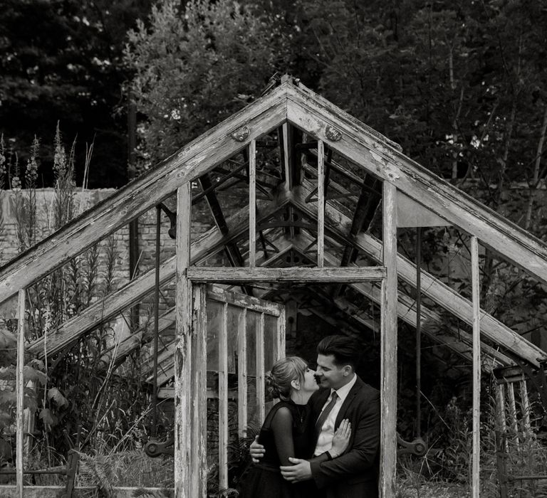 Bride & groom stand outside in black and white post-wedding photoshoot