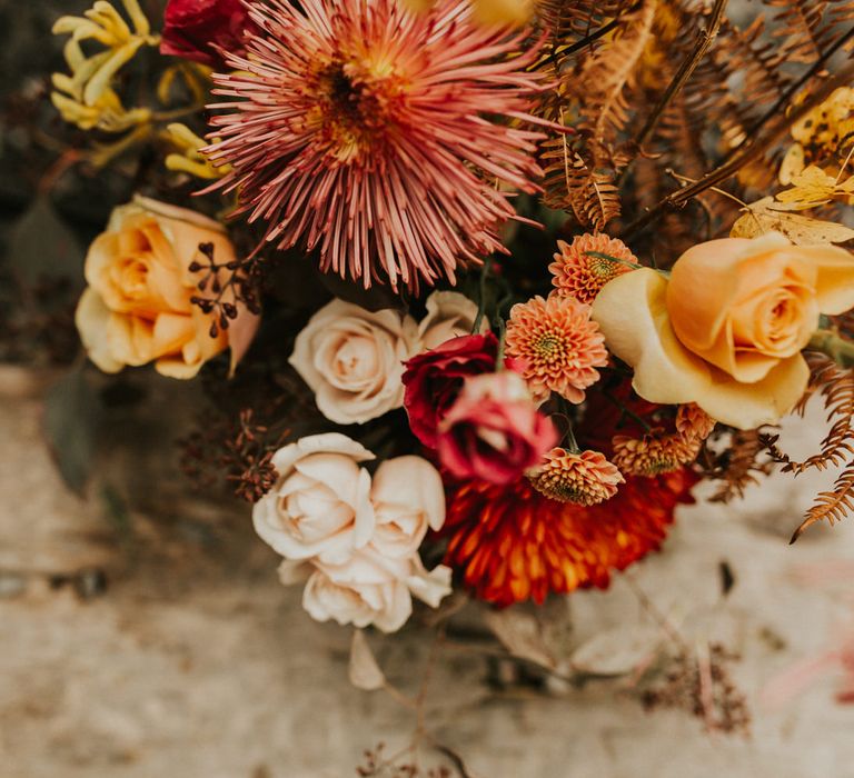 Red, yellow, orange and peach wedding flowers for Moroccan and, autumn themed wedding at Anran 