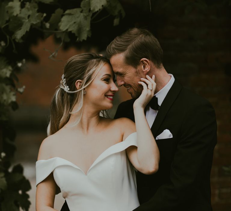 Groom leans in to kiss bride on wedding day