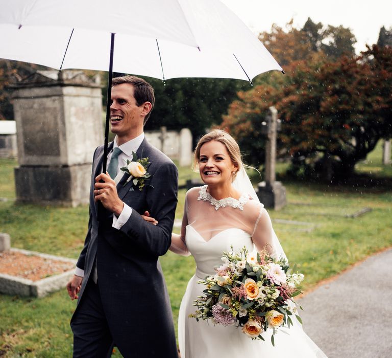 Bride & groom walking together after wedding ceremony