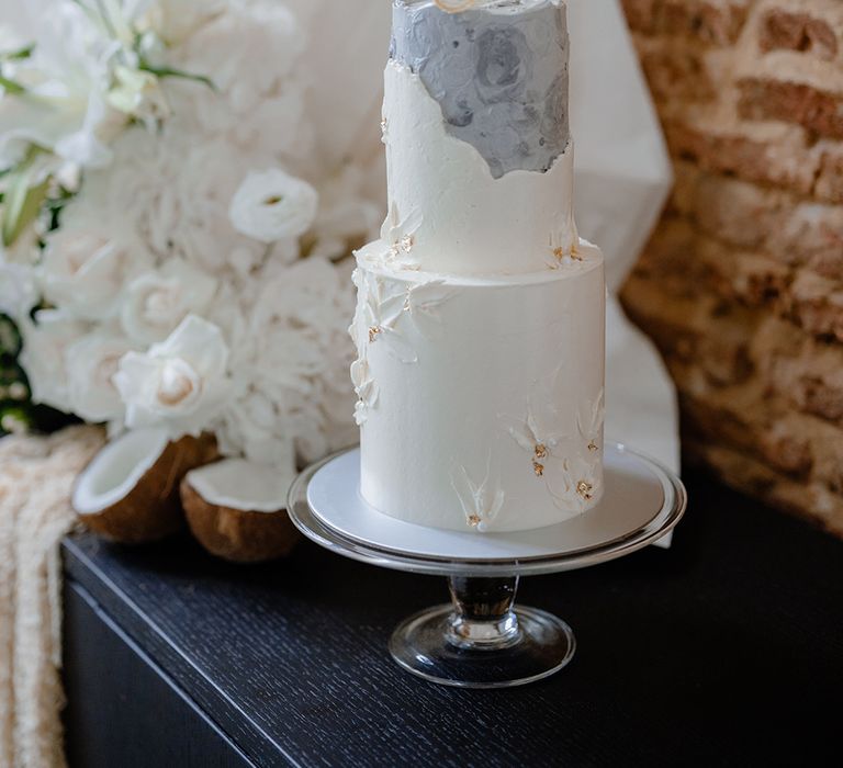 Two tier buttercream wedding cake with marble design and sugar sculpture cake topper 