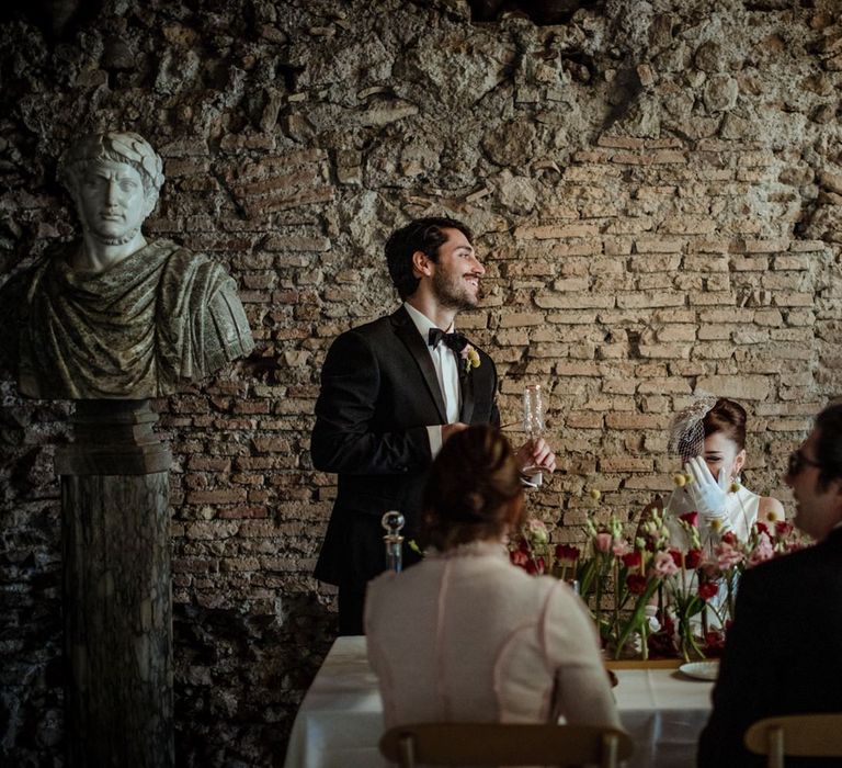 The groom making a toast at their intimate wedding meal with two guests