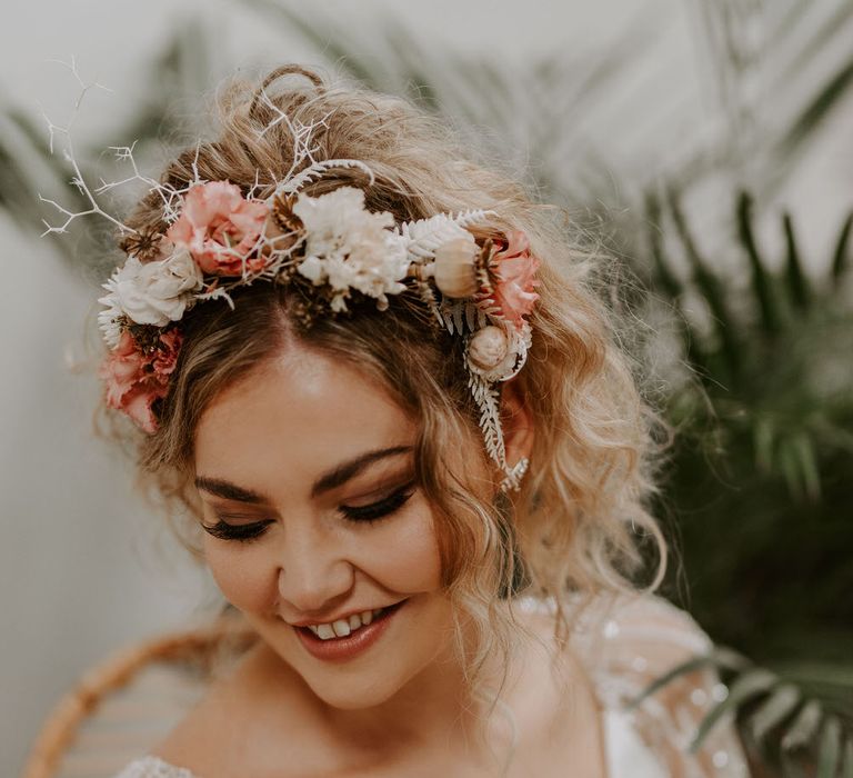 Bride wearing a tropical themed pink and white headband, with jewelled chiffon flowing short sleeved wedding dress