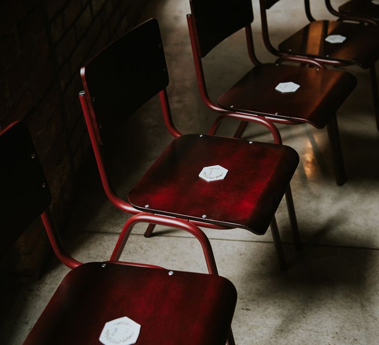 Dark wooden seats at a wedding reception. 