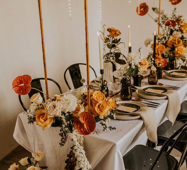 Orange anthuriums and mustard yellow roses wedding table flowers 