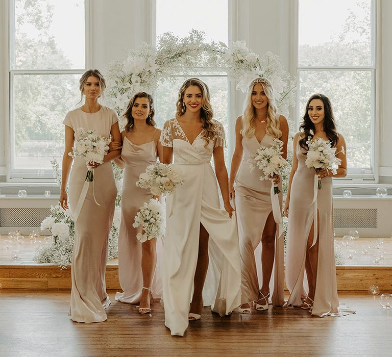 Bridal party portrait with satin a lace wrap wedding dress and champagne gold bridesmaid dresses 