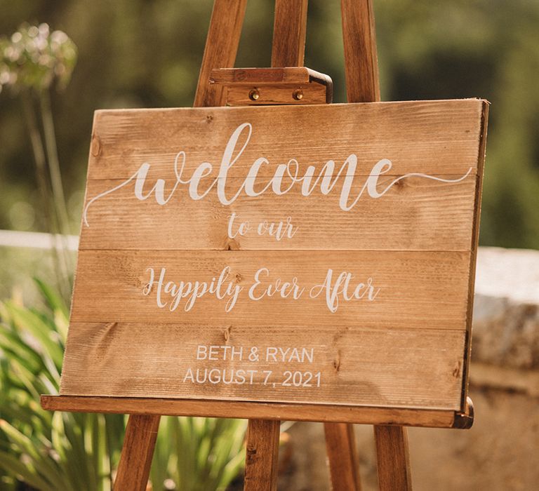 Wooden wedding welcome sign with white calligraphy