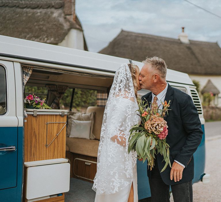 Bride kisses her father on her wedding day