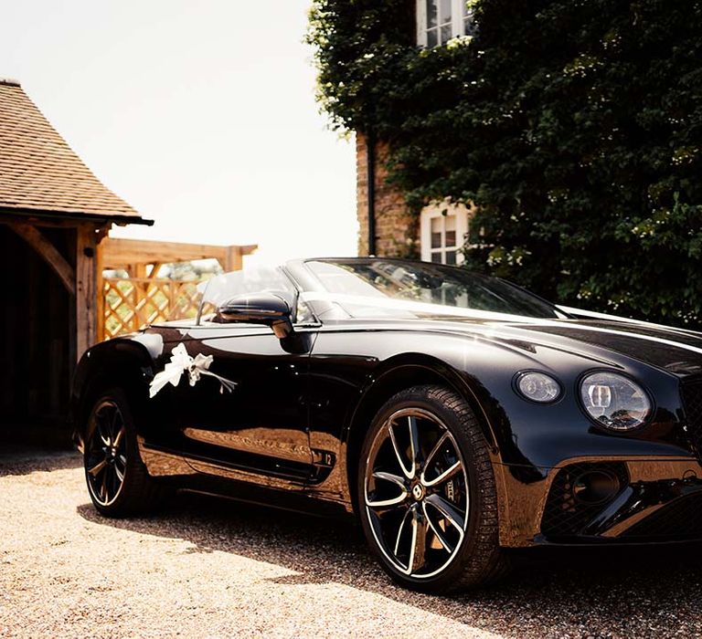 Black wedding car with ribbon decoration