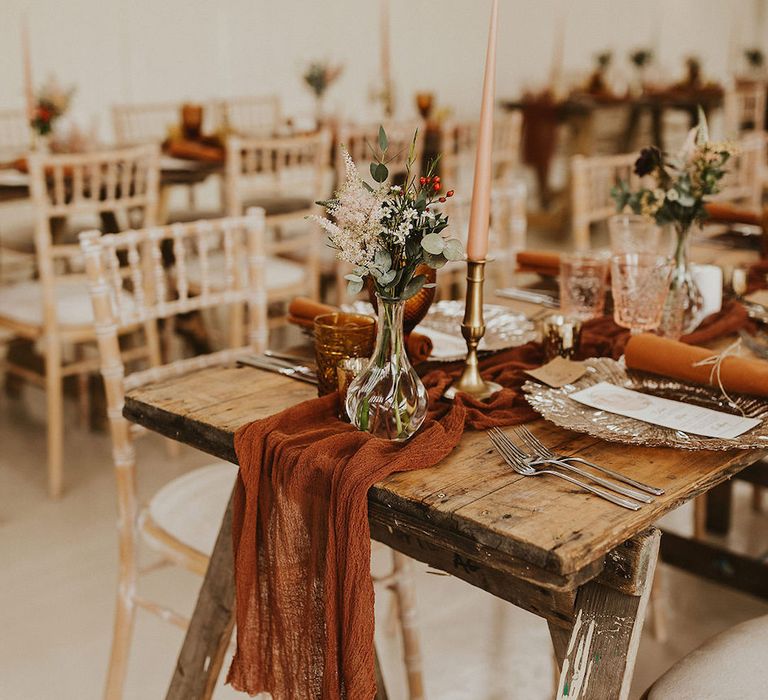 Rust linen table runners with gold candlesticks