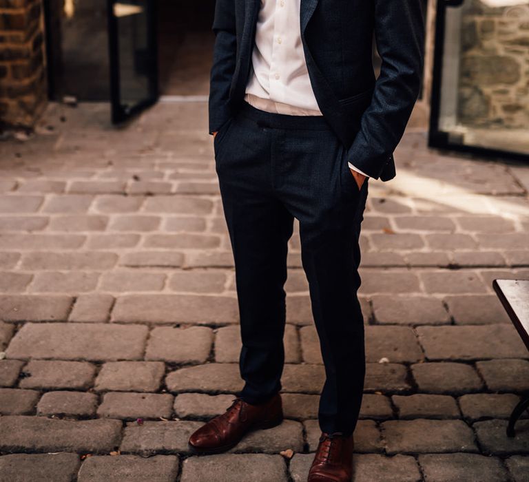 Groom stands outdoors 