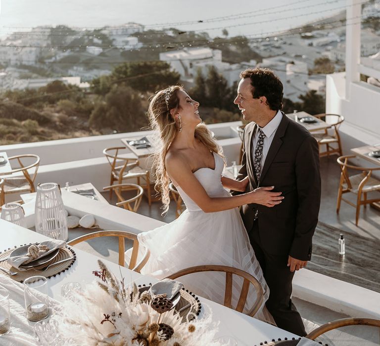 Bride & groom laugh outdoors on their wedding day