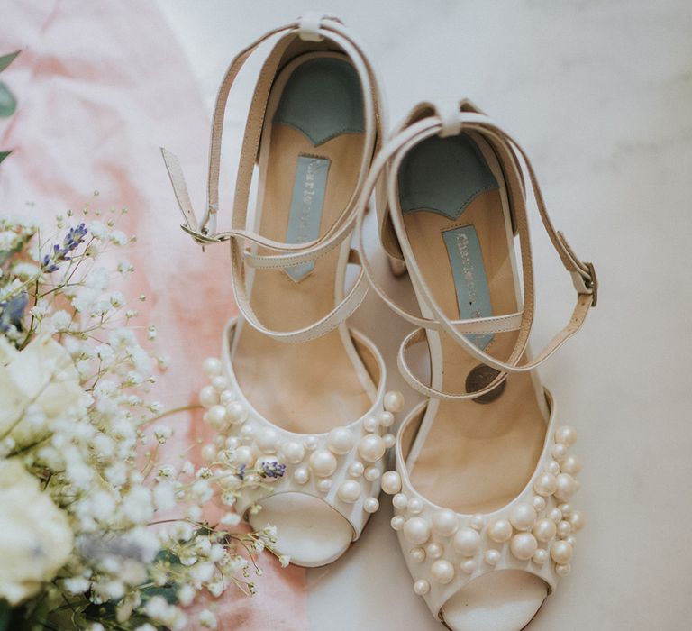 Charlotte Mills pearl wedding shoes with enagagement ring and gypsophila and lavender wedding bouquet