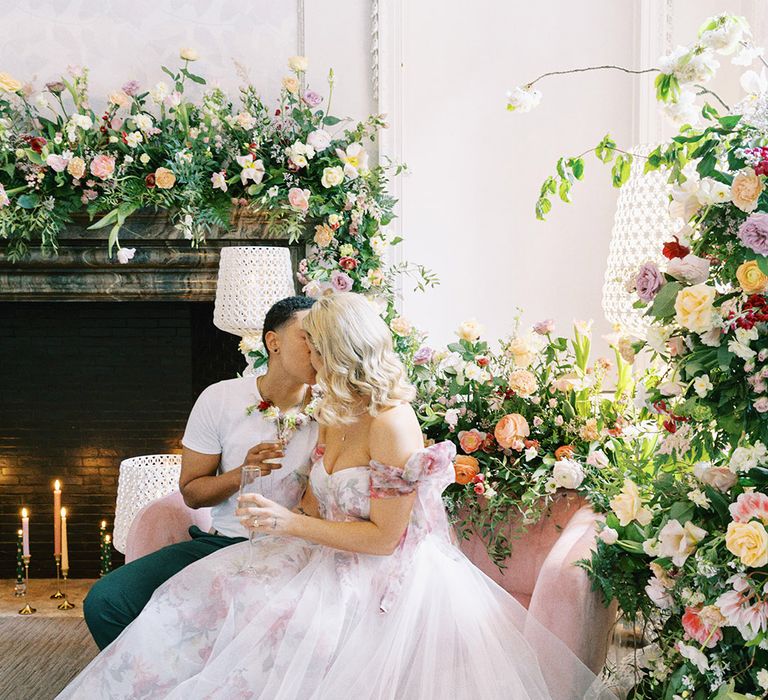 Bride in a pink flower motif wedding dress with tulle overlay 