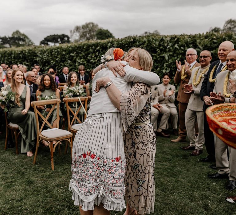 Multicultural ceremony with a Milni ritual, a joining of 2 families by swapping flower garlands