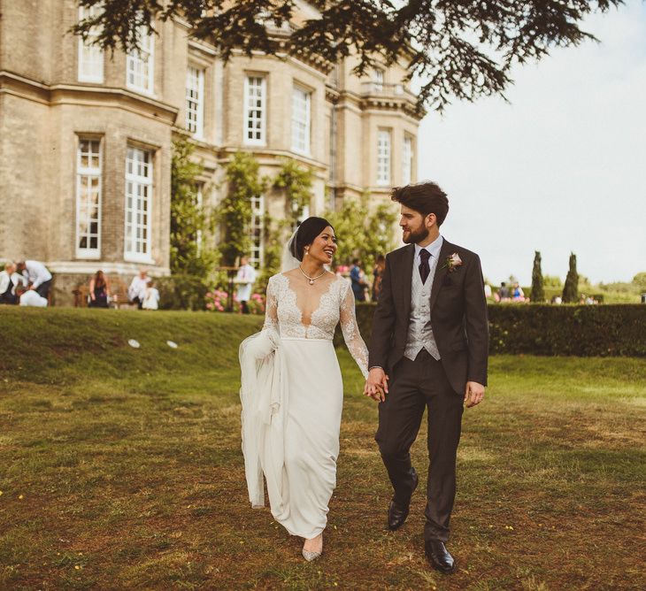 Bride and groom walking though the grounds at their Hedor House wedding