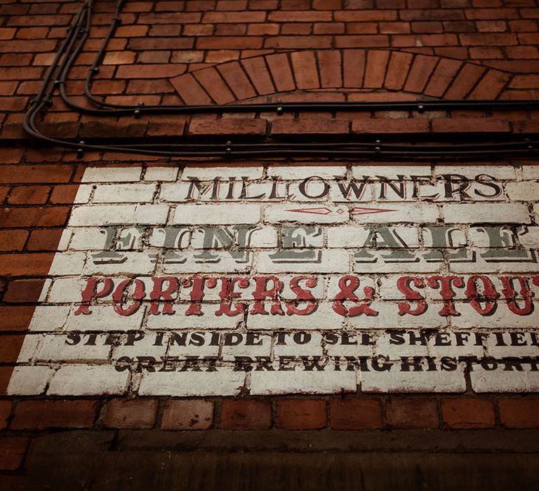 Sign painted on to brick wall with vintage style 